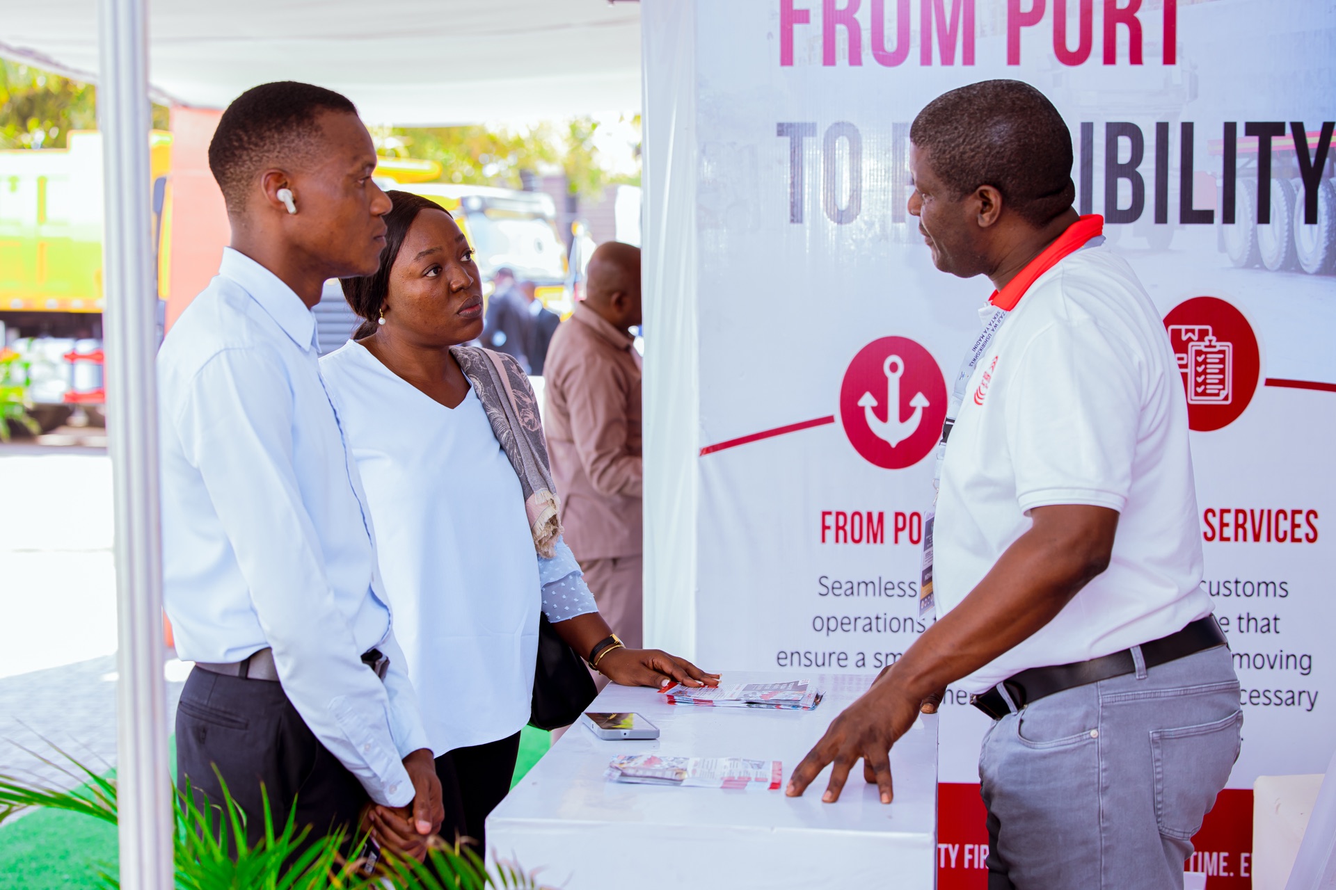SAS Logistics representative speaking with visitors at the LCCF 2026 exhibition booth in Mwanza, Tanzania